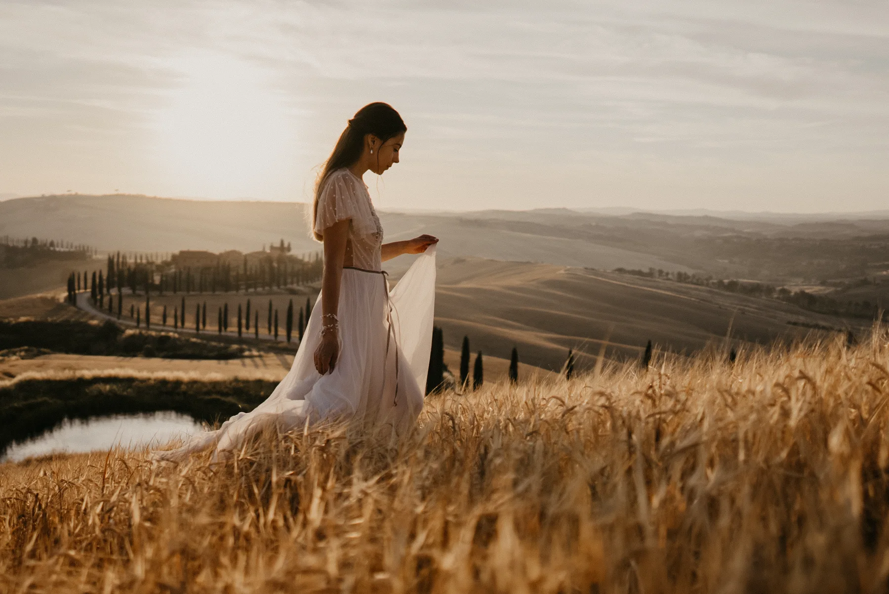 Bride in the Tuscan landscape at sunset