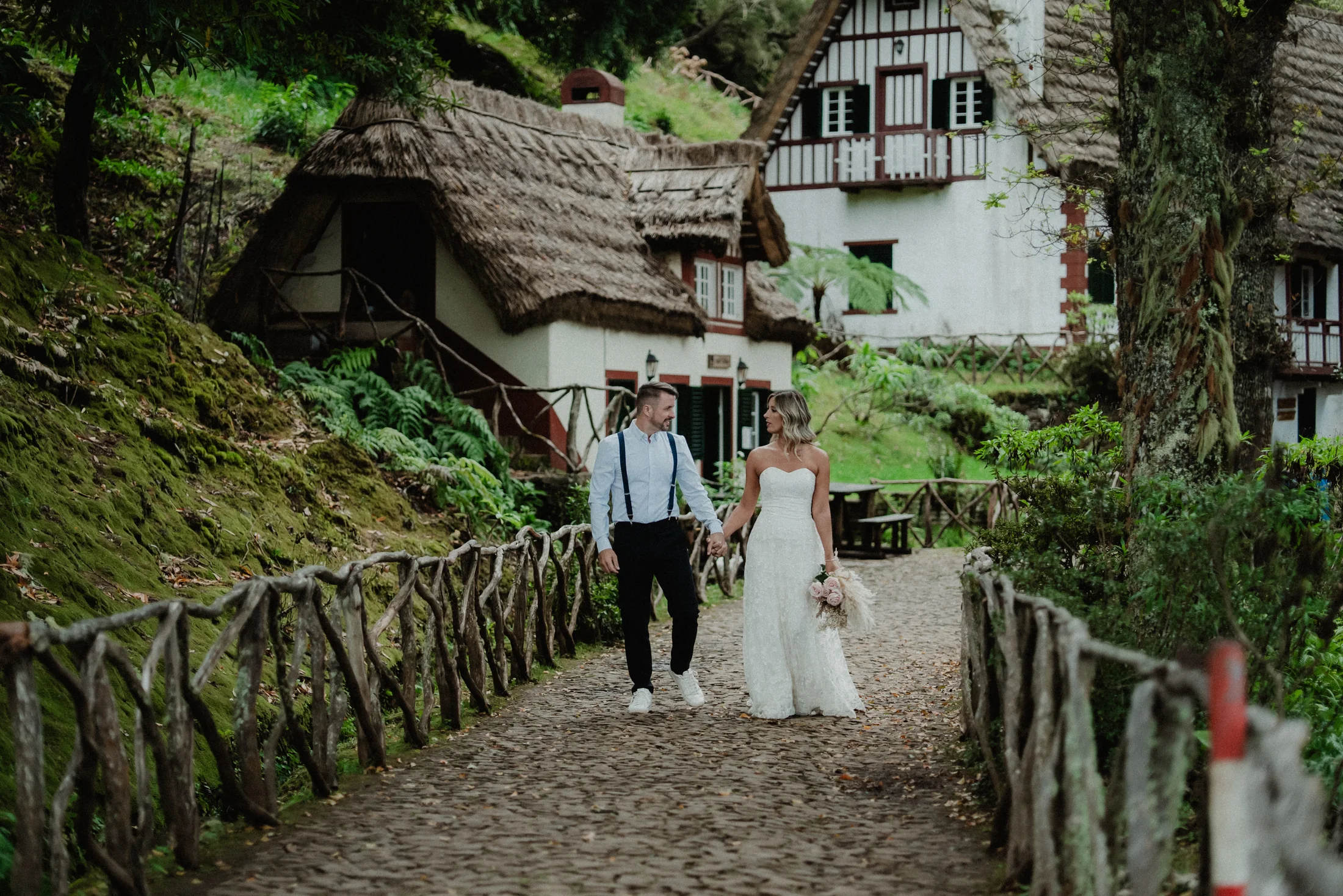 Couple walking through traditional houses in Madeira