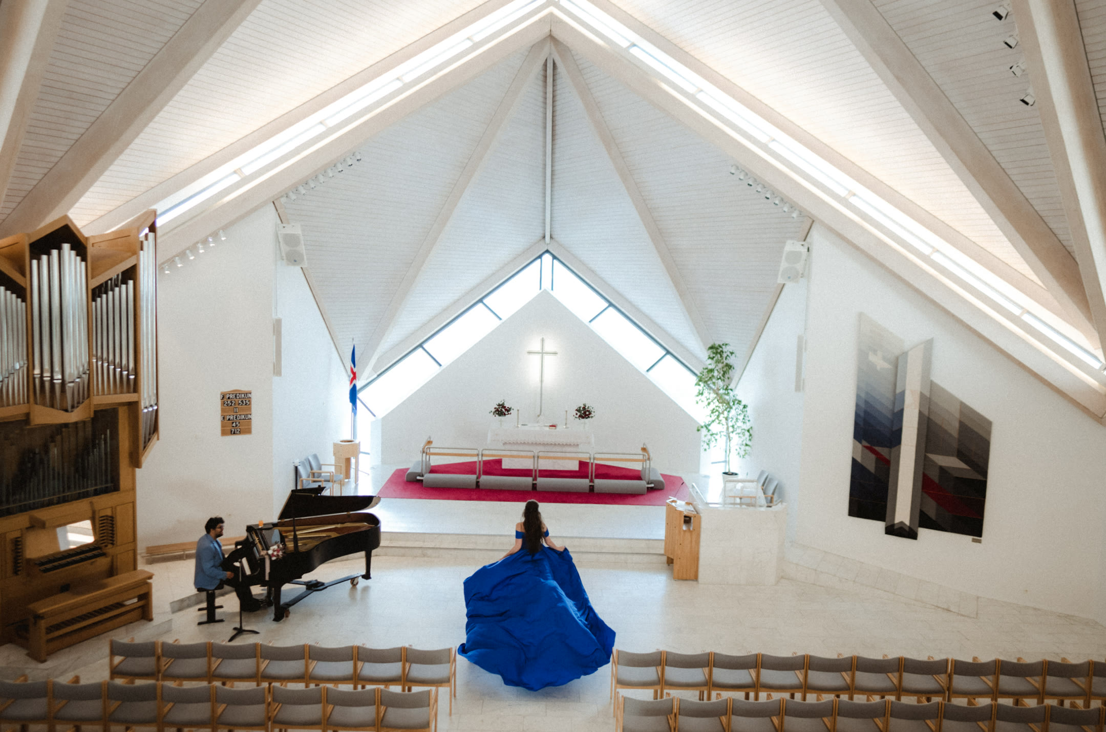 Georgiana in a blue gown inside a Reykjavik church during her Iceland elopement